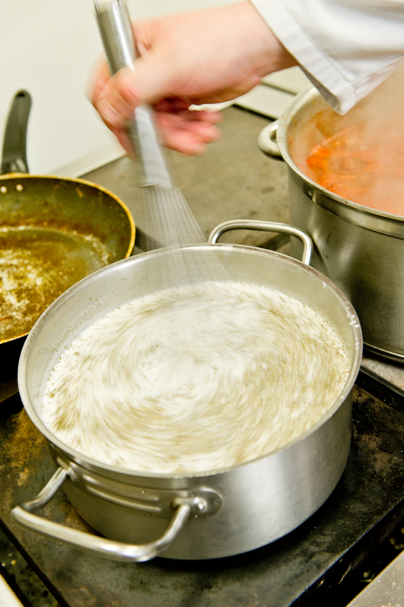 Chef stirring saucepan contents
